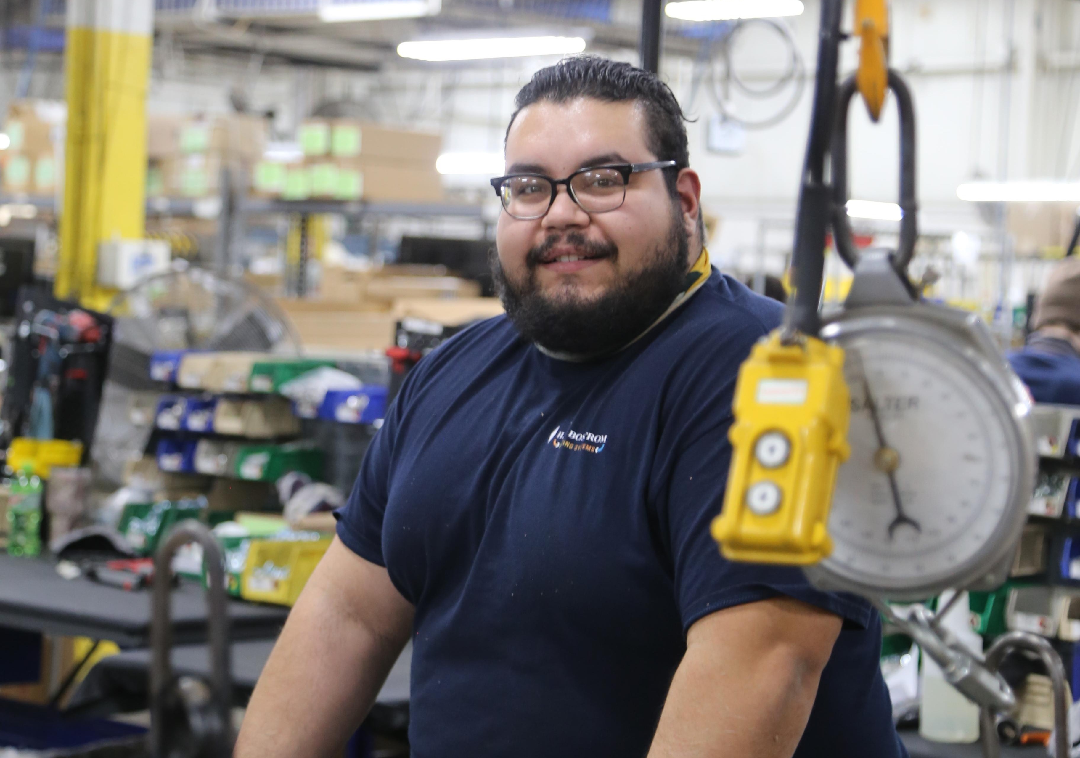 Manufacturing plant employee smiling at work-1